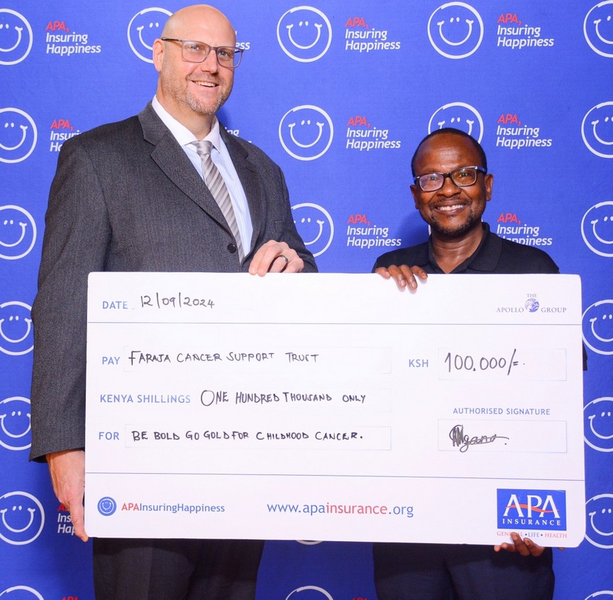 Eric Wanting presents a cheque to David Makumi of Faraja Cancer Support Trust